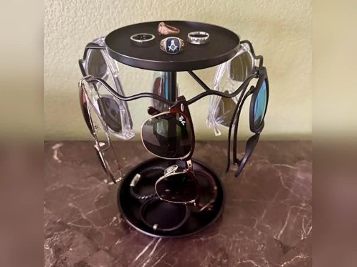 Rotating sunglasses organizer with metal frame, accessory trays and multiple pairs of glasses